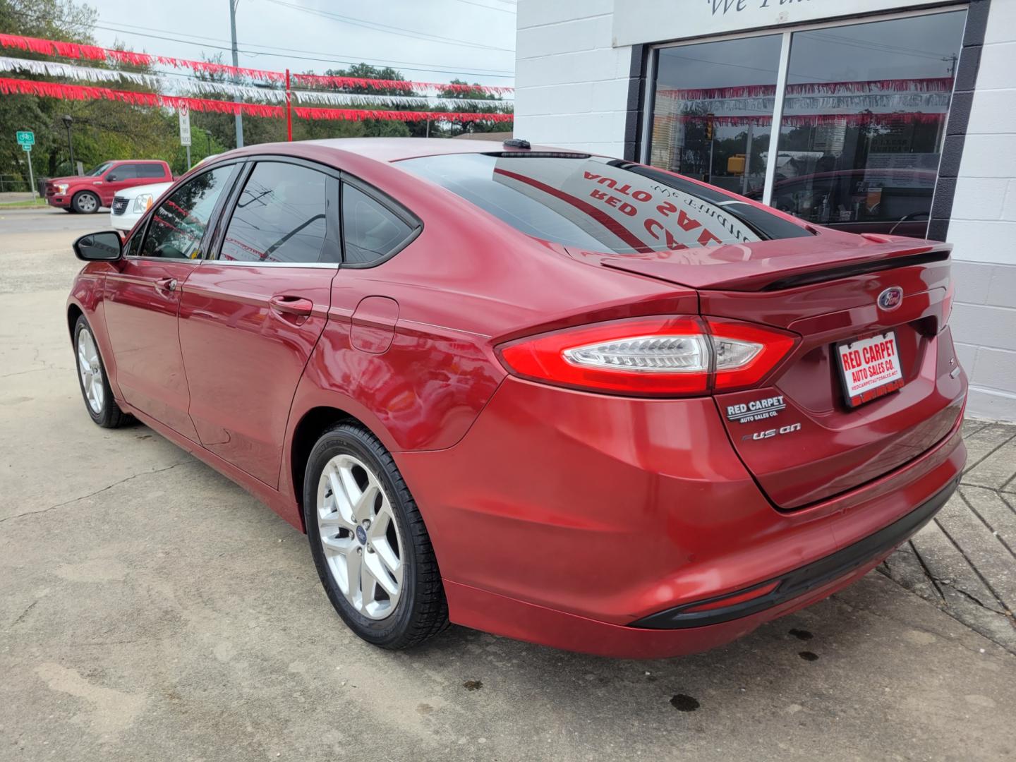 2013 Red Ford Fusion (3FA6P0HR3DR) with an 1.6L I4 F DOHC 16V engine, Automatic transmission, located at 503 West Court, Seguin, TX, 78155, (830) 379-3373, 29.568621, -97.969803 - 2013 Ford Fusion SE with a 1.6L I4 F DOHC 16V, Automatic, Tilt, Cruise, AM/FM/CD Stereo, Power Windows, Locks, Seat and Side Mirrors, Bluetooth, Automatic Headlights, Tinted Windows, Alloy Wheels, Rear Defroster and more!! - Photo#3